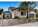Charming single-story home with desert landscaping, RV parking and a brick driveway at 8811 Pauley Hills St, Las Vegas, NV 89131