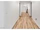 Bright hallway with wood-style flooring leading to the front door at 8811 Pauley Hills St, Las Vegas, NV 89131