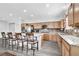 Well-equipped kitchen with a large island, stainless steel appliances, and ample counter space with bar seating at 8811 Pauley Hills St, Las Vegas, NV 89131