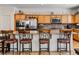 Modern kitchen with granite counters, stainless steel appliances, and wooden cabinets at 8811 Pauley Hills St, Las Vegas, NV 89131