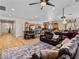 Spacious living room open to the kitchen with tiled floors and a large leather sofa at 8811 Pauley Hills St, Las Vegas, NV 89131