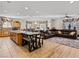 Spacious living area featuring a kitchen island, dining table, and leather sofa at 8811 Pauley Hills St, Las Vegas, NV 89131