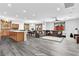 Open-concept living space with hardwood floors, modern lighting, and comfortable seating. Includes a kitchen and dining area at 8811 Pauley Hills St, Las Vegas, NV 89131