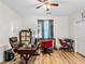 Office area with wood-look floors, ceiling fan, and natural light at 8811 Pauley Hills St, Las Vegas, NV 89131
