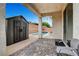This patio features an outdoor storage shed with a pool in the background at 8811 Pauley Hills St, Las Vegas, NV 89131