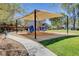 Community playground with shade, equipment and seating for residents at 8811 Pauley Hills St, Las Vegas, NV 89131
