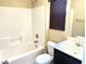 Bathroom featuring a tub, shower, toilet and a vanity with dark wood cabinetry at 9535 Leaping Lizard St, Las Vegas, NV 89178