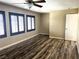 Spacious bedroom features hardwood floors, a ceiling fan, and three shuttered windows at 9535 Leaping Lizard St, Las Vegas, NV 89178