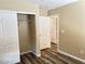 Bedroom featuring wood-look floors, closet, and open doorways to other rooms at 9535 Leaping Lizard St, Las Vegas, NV 89178
