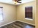 Cozy bedroom with wood-look floors and horizontal blinds on the windows at 9535 Leaping Lizard St, Las Vegas, NV 89178