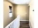 Hallway with wood-look floors and a staircase with white railing at 9535 Leaping Lizard St, Las Vegas, NV 89178