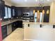Well-appointed kitchen featuring granite countertops, stainless appliances, and dark wood cabinetry at 9535 Leaping Lizard St, Las Vegas, NV 89178