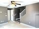 Inviting living area featuring tile floors and staircase with neutral paint colors at 9535 Leaping Lizard St, Las Vegas, NV 89178