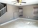 Spacious living room featuring neutral color palette, tiled flooring, and staircase at 9535 Leaping Lizard St, Las Vegas, NV 89178