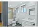 Clean bathroom featuring tile flooring, a shower-tub combo, and a modern vanity at 9709 Terrace Green Ave, Las Vegas, NV 89117