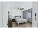 Comfortable bedroom with hardwood floors, ceiling fan, and a large window at 9709 Terrace Green Ave, Las Vegas, NV 89117
