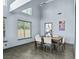 Dining room with large windows offering natural light and views into the kitchen at 9709 Terrace Green Ave, Las Vegas, NV 89117