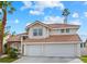 Stunning two-story home with a red-tiled roof, featuring a dual-car garage and meticulous landscaping at 9709 Terrace Green Ave, Las Vegas, NV 89117