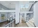 Bright open-concept foyer showcasing the staircase, dining area, and views to other living spaces at 9709 Terrace Green Ave, Las Vegas, NV 89117