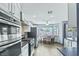 Updated kitchen features stainless steel appliances, white cabinets, and adjacent breakfast nook with natural light at 9709 Terrace Green Ave, Las Vegas, NV 89117