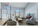 Bright living room with vaulted ceilings, large windows, and comfortable seating arrangement at 9709 Terrace Green Ave, Las Vegas, NV 89117