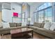 Inviting living room featuring a soaring ceiling, large windows, and comfortable seating at 9709 Terrace Green Ave, Las Vegas, NV 89117