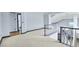 Spacious loft area with neutral carpeting, gray trim and staircase access at 9709 Terrace Green Ave, Las Vegas, NV 89117