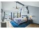 Spacious main bedroom features high ceilings, a ceiling fan, French doors, and a large window overlooking the backyard at 9709 Terrace Green Ave, Las Vegas, NV 89117