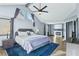 Inviting main bedroom offers a cozy fireplace, a ceiling fan, wood floors, and a comfortable sitting area at 9709 Terrace Green Ave, Las Vegas, NV 89117