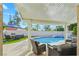 Inviting covered patio overlooks the sparkling pool and lush backyard, perfect for outdoor entertaining at 9709 Terrace Green Ave, Las Vegas, NV 89117