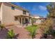 Landscaped backyard with a covered patio, desert landscaping and a grassy area at 10103 Flagstaff Butte Ave, Las Vegas, NV 89148