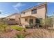 Spacious backyard with desert landscaping, a covered patio, and partial fencing at 10103 Flagstaff Butte Ave, Las Vegas, NV 89148
