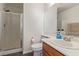 Bathroom with walk-in shower, toilet, sink, and wood cabinets, ideal for everyday use at 10103 Flagstaff Butte Ave, Las Vegas, NV 89148