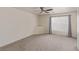 Bright bedroom featuring neutral walls, plush carpeting, ceiling fan, and natural light from large window at 10103 Flagstaff Butte Ave, Las Vegas, NV 89148