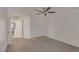 Spacious bedroom with neutral walls, plush carpeting, ceiling fan, and bright open doorway at 10103 Flagstaff Butte Ave, Las Vegas, NV 89148