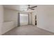 Cozy bedroom with neutral walls, plush carpeting, ceiling fan, and bright window, offering comfortable living space at 10103 Flagstaff Butte Ave, Las Vegas, NV 89148
