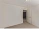 Neutral-toned bedroom with an open white door and neutral carpet at 10103 Flagstaff Butte Ave, Las Vegas, NV 89148