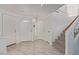 Entryway featuring tiled floors, multiple closets, carpeted stairs, and natural light at 10103 Flagstaff Butte Ave, Las Vegas, NV 89148