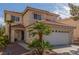Inviting two-story home with a red tile roof, desert landscaping, and attached two-car garage at 10103 Flagstaff Butte Ave, Las Vegas, NV 89148
