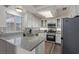 Bright kitchen features granite countertops, stainless steel appliances, and white cabinetry at 10103 Flagstaff Butte Ave, Las Vegas, NV 89148