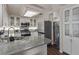 Kitchen featuring granite countertops, stainless steel appliances, white cabinetry, and skylight at 10103 Flagstaff Butte Ave, Las Vegas, NV 89148