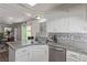 Bright kitchen featuring granite countertops, stainless steel appliances, mosaic backsplash and white cabinetry at 10103 Flagstaff Butte Ave, Las Vegas, NV 89148