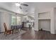 Open living room featuring a view of the kitchen, dark laminate flooring, and lots of natural light at 10103 Flagstaff Butte Ave, Las Vegas, NV 89148