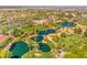 Expansive aerial view of a Primary-planned community with scenic lakes, golf course, and lush landscaping at 10290 Profeta Ct, Las Vegas, NV 89135