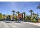 Beautiful clubhouse with palm trees, manicured landscaping, and convenient parking at 10290 Profeta Ct, Las Vegas, NV 89135
