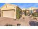 Attractive single-story home with desert landscaping, a brick walkway, and a two-car garage at 10290 Profeta Ct, Las Vegas, NV 89135