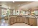 Well-lit kitchen featuring custom cabinets, granite countertops, stainless steel appliances, and a breakfast nook at 10290 Profeta Ct, Las Vegas, NV 89135