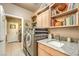 Organized laundry room includes modern washer and dryer, and ample storage at 10290 Profeta Ct, Las Vegas, NV 89135