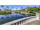 Scenic pond with waterfall feature, lush greenery, and picturesque landscaping at 10290 Profeta Ct, Las Vegas, NV 89135