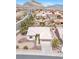 Aerial view of home with desert landscaping, paver driveway, and mature palm trees at 10920 Black Ledge Ave, Las Vegas, NV 89134